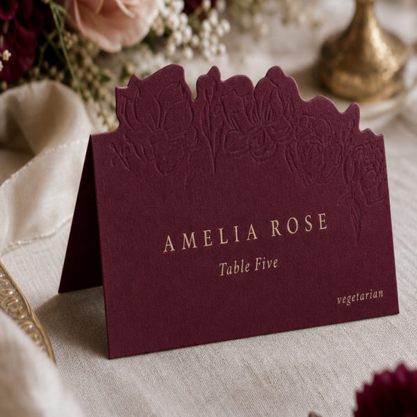 Burgundy die-cut place card with gold lettering