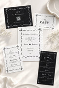 Ribbon & Ink hand-drawn wedding invitation suite in black and white, styled on silk with baby's breath